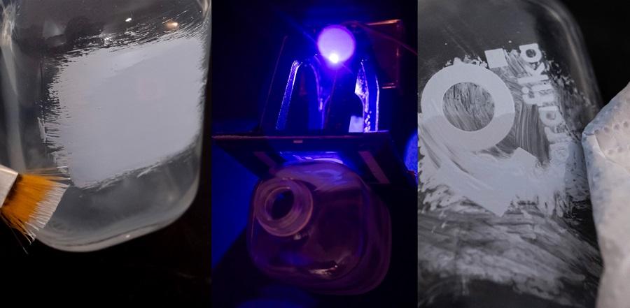 The process of printing the Department of Graphic Design logo onto a glass bottle, applying UV ink and exposing the print