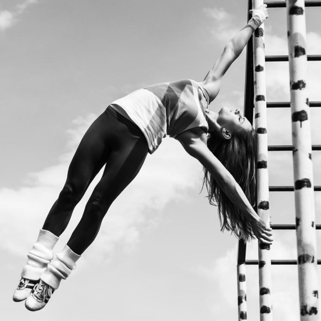 Girl exercising on monkey bars