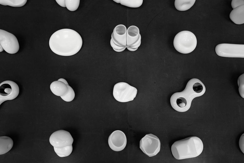 A monochromatic flat lay photograph capturing a section of the exhibition featuring ceramic artworks