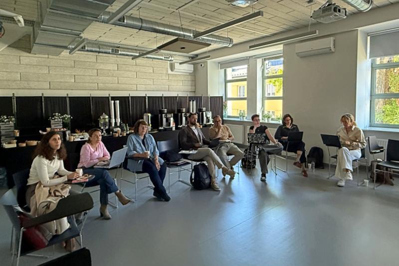 Members of the AI-CARE project sit in a circle during workshop