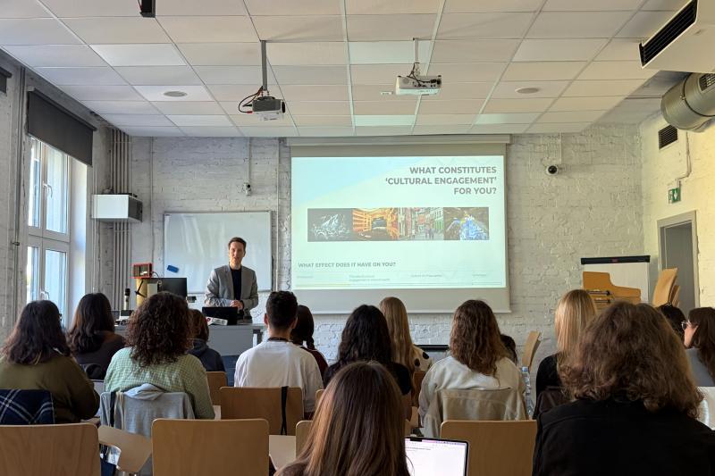 Students listen to a lecture and watch a presentation on cultural engagement at USWPS in Katowice