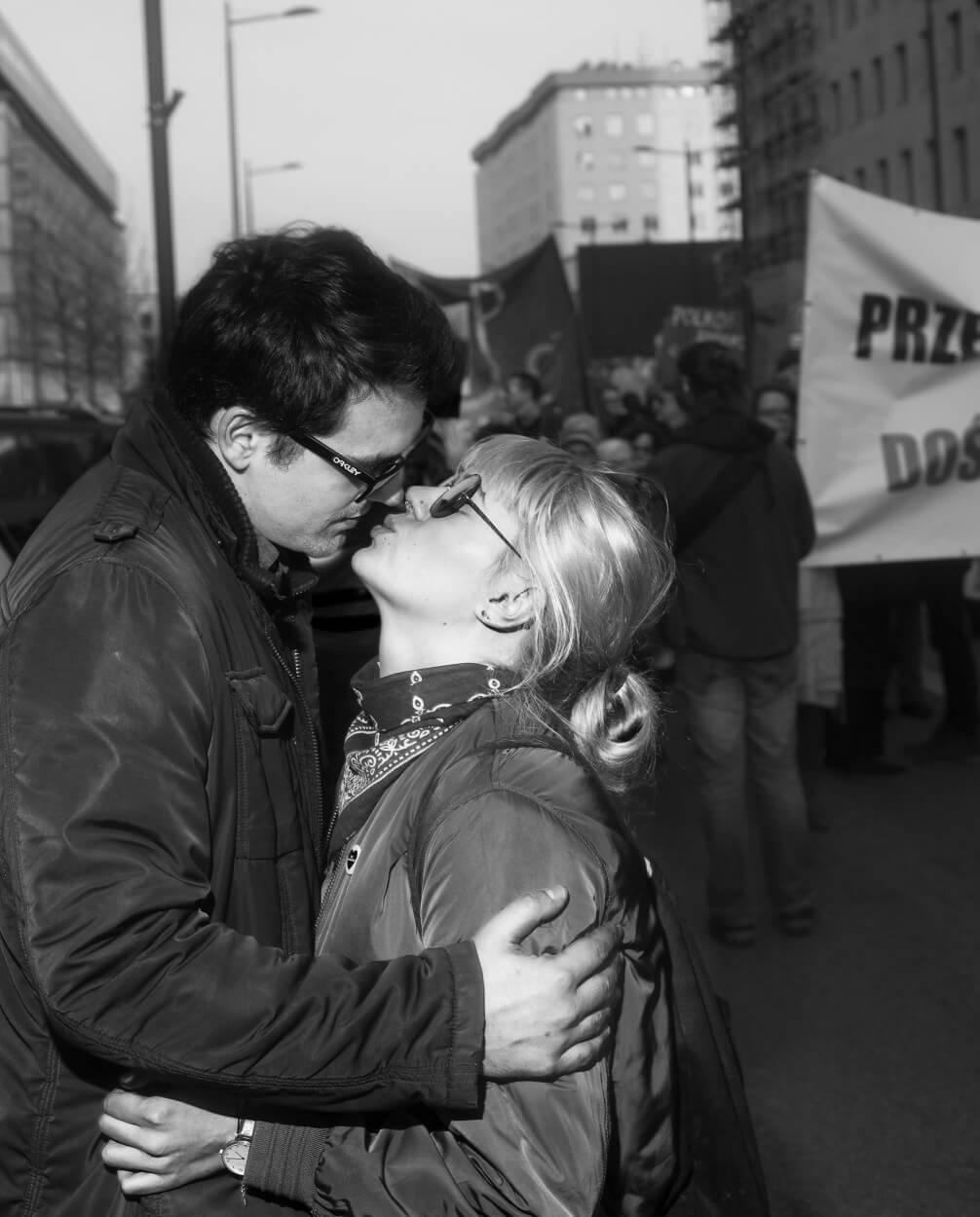 A couple shares a kiss during a protest