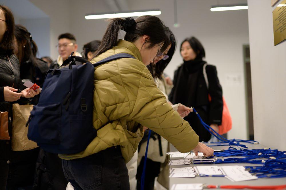 Chinese language teachers receiving seminar badges at SWPS University