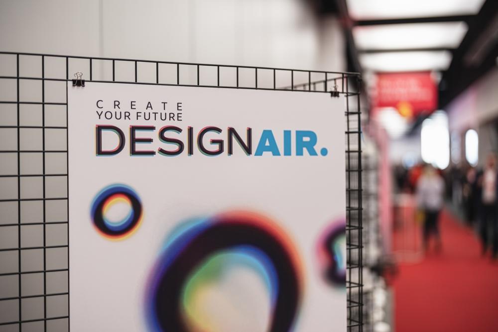 Close-up view of the upper section of the exhibition poster with a slogan "Create your future. DesignAIR"