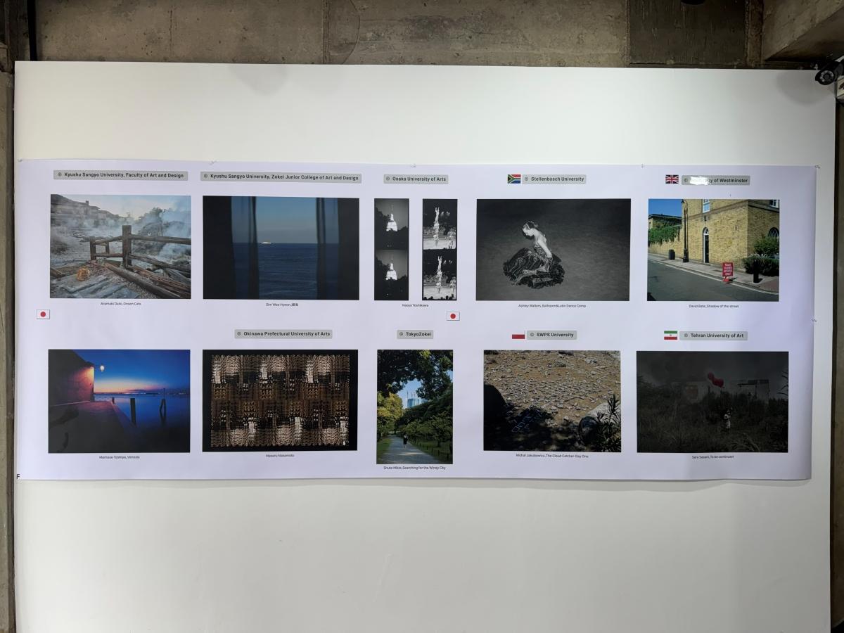 The photos are hung in two rows on a concrete wall.