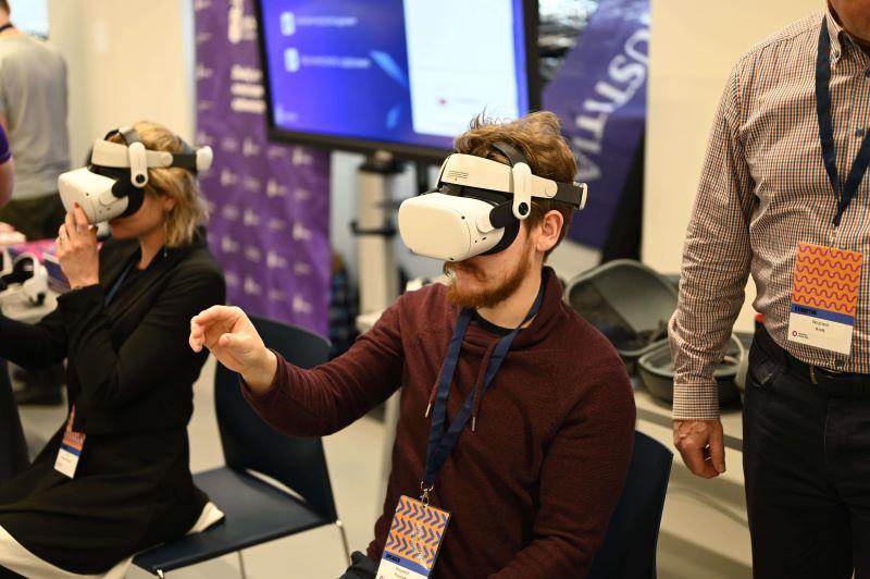 People using virtual reality headsets during HumanTech Summit 2023 at SWPS University