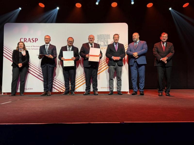 Research Impact Leaders Award 2025 ceremony; representatives of the universities authorities, including the rector of SWPS University, standing on the stage