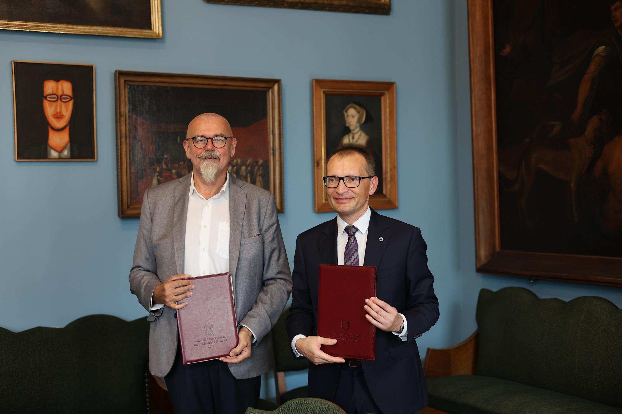 The Rector of SWPS University and the Rector of the Academy of Fine Arts in Krakow, holding documents related to the collaboration