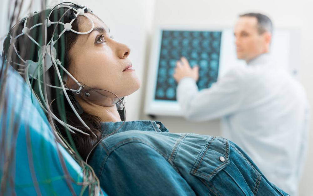 Woman undergoing brain screening with electroencephalogram