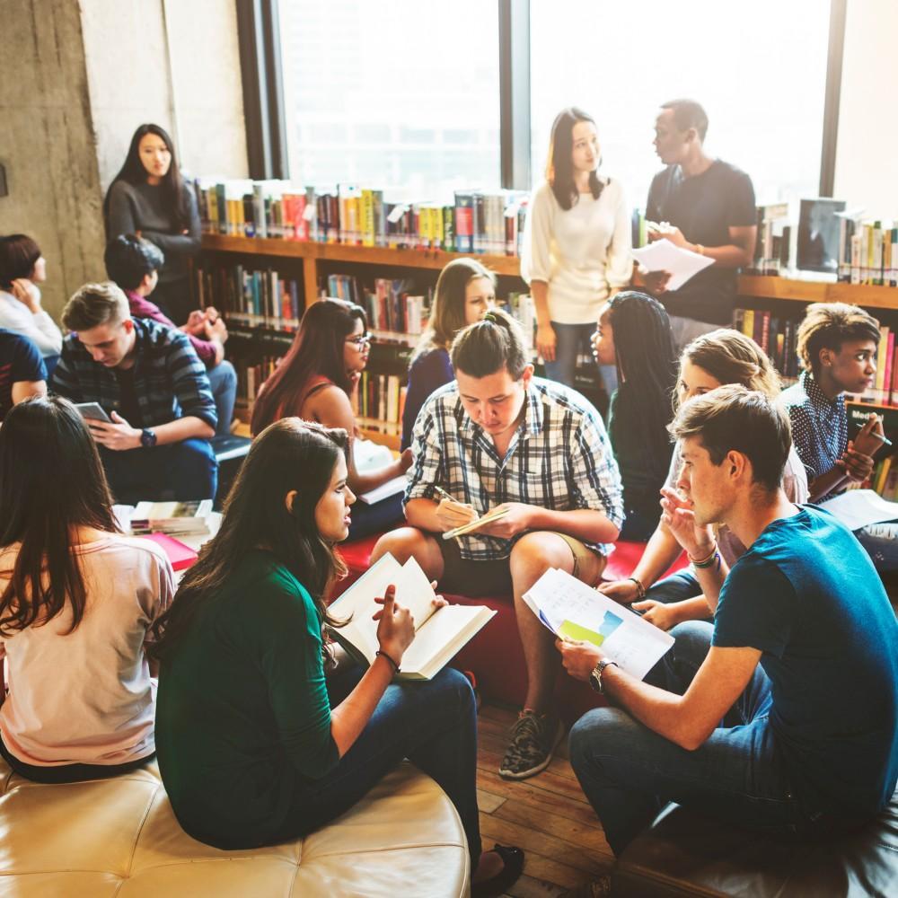 University students working in groups in a library