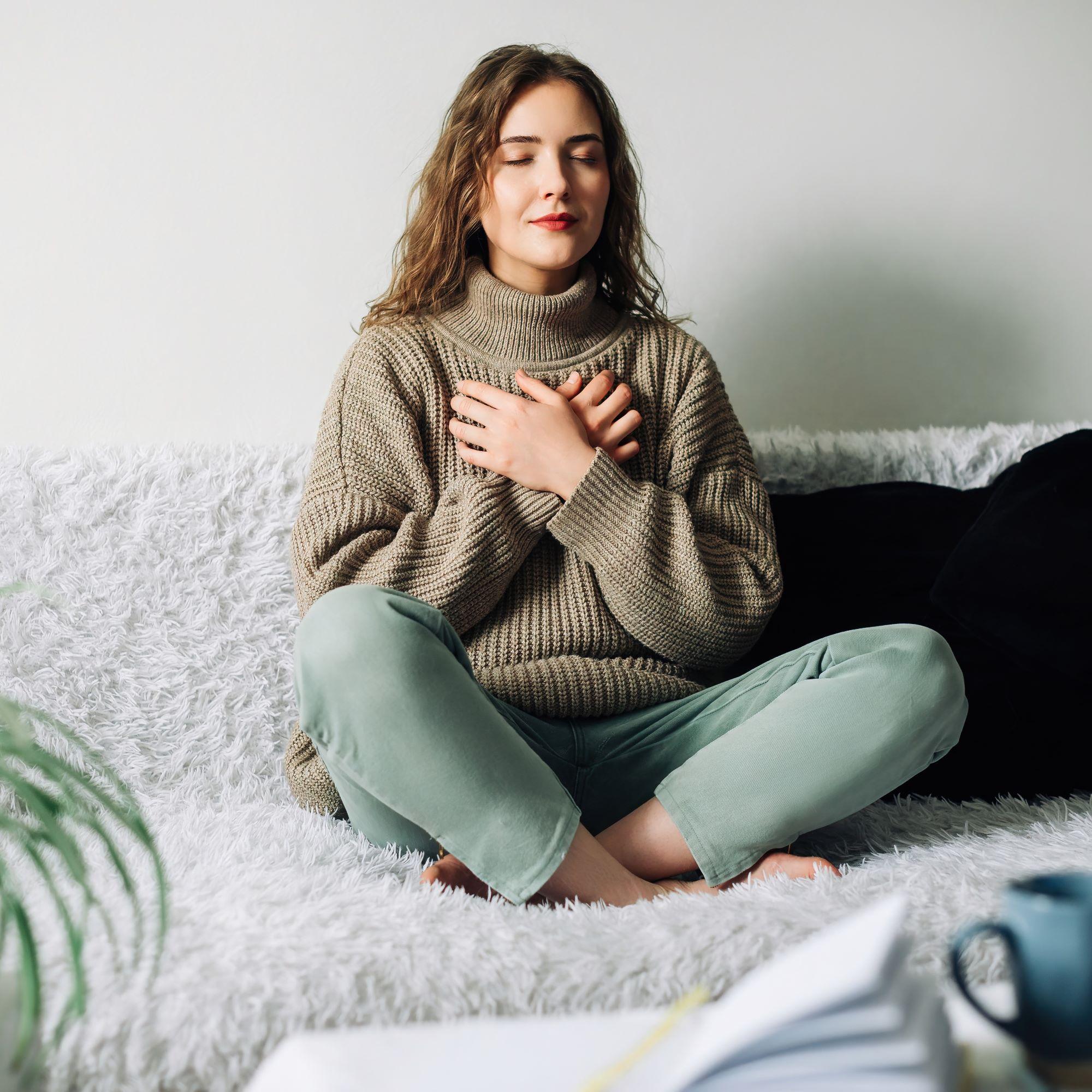 Woman meditating on her couch