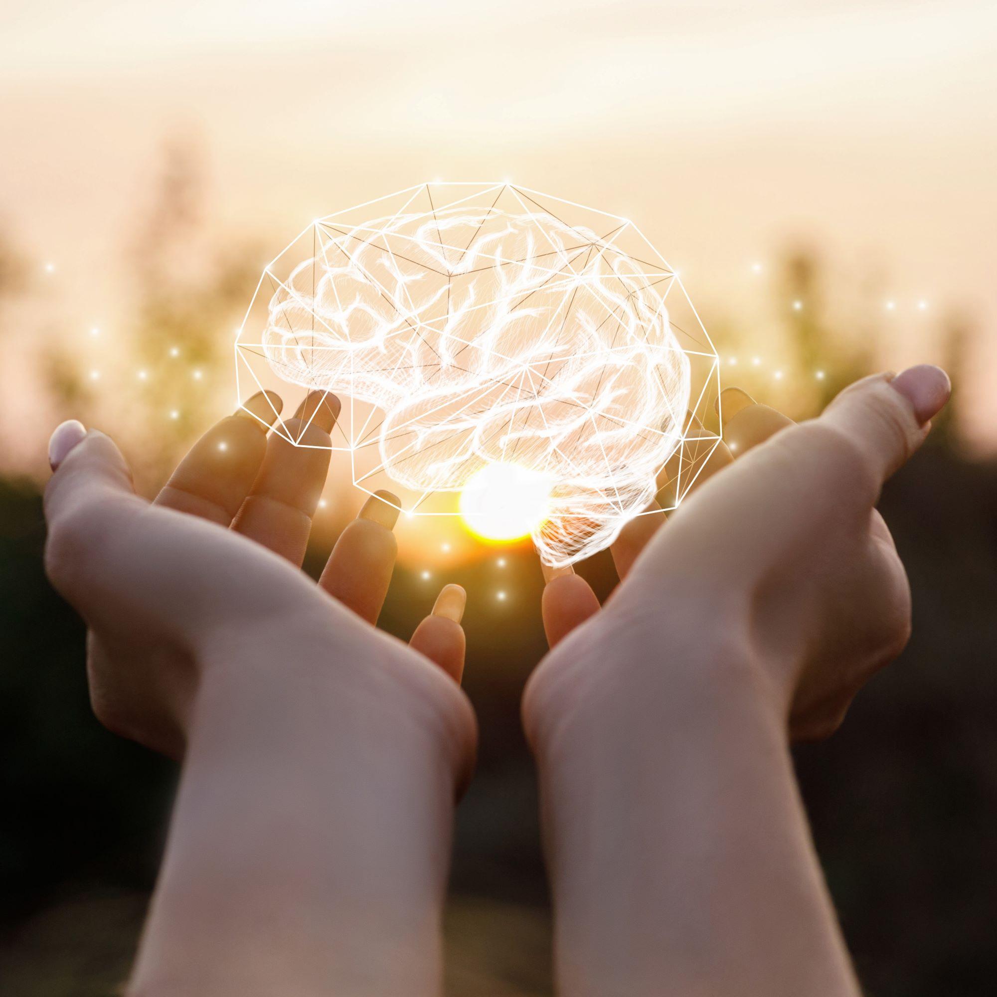 Woman holding a hologram of a brain in her hands