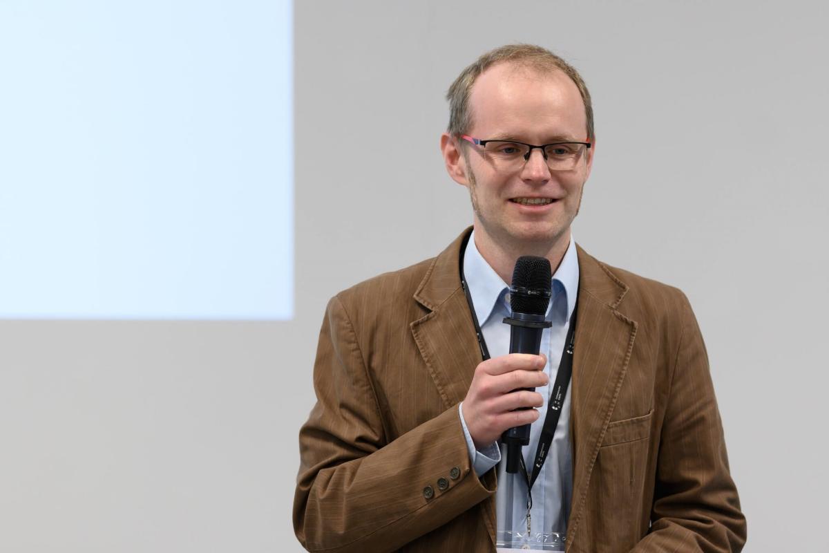 Mikołaj Rogiński speaking at a conference on social innovation and quality of life at SWPS University