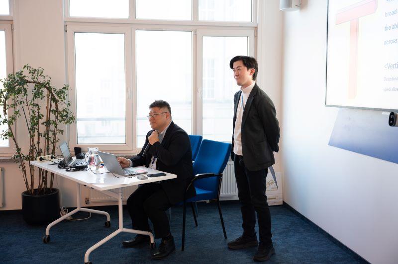 Two men of Asian descent giving a presentation