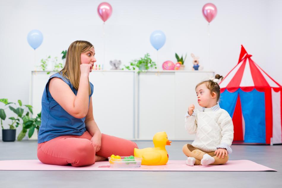 Behavioral psychologists works with a girl with Down syndrome